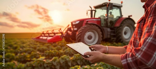Farmer s hands using tablet in field, tractor, and farm with blurred background for text placement