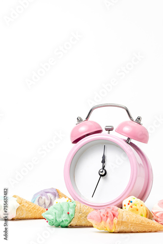vintage pink alarm clock with ice cream cone on a white background. copy space.template for design