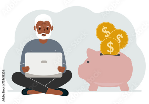 A man sits cross-legged with a laptop next to a pig piggy bank. Earning money, saving, saving money.