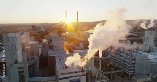 Iindustrial chemical plant with high pipes in bright light of winter sunset aerial view. SOLVEY SODI JSC Devnya, Bulgaria Synthetic soda ash production plant. Thick smoke comes from high pipe. Ecology photo