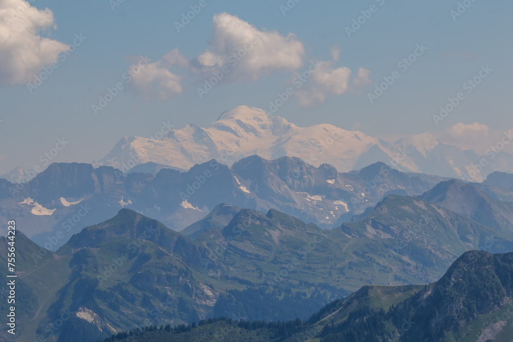 a mountain with some mountains on both sides and a clear blue sky