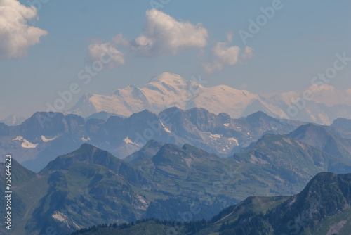 a mountain with some mountains on both sides and a clear blue sky © Wirestock
