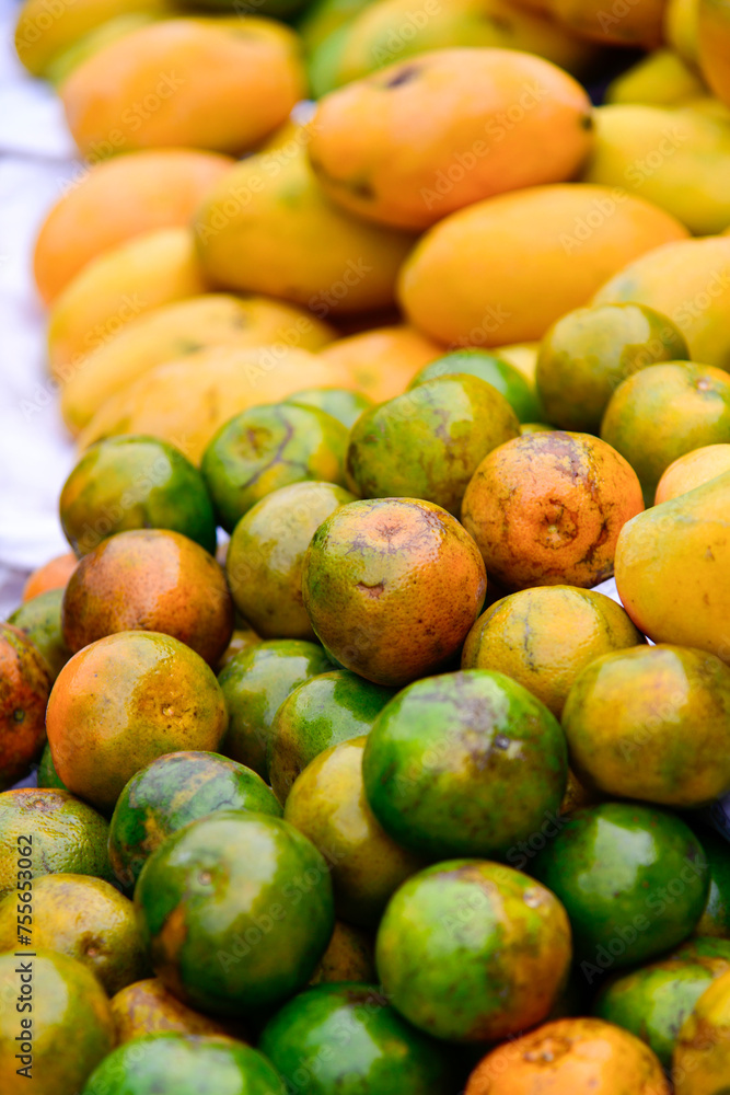 View of the oranges and mangos on sale in the street market View of the oranges and mangos on sale in the street market