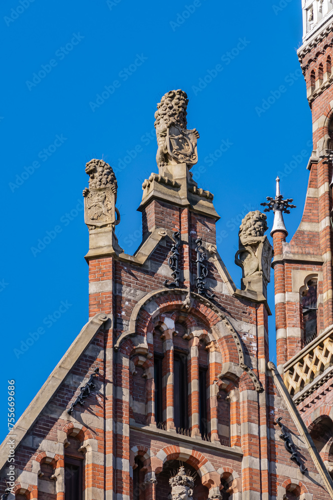 Fototapeta premium Architectural detail of Neo-Gothic Magna Plaza building (1899). Magna Plaza, formerly known as Amsterdam Main Post Office, is monument part of Dutch Top 100 heritage sites. AMSTERDAM, The NETHERLANDS.