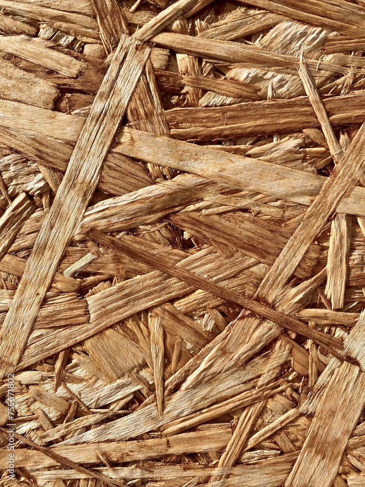The pressed wood surface of sawdust close-up. The texture of the chipboard background. Recycling and reuse of wood The pressed wood surface of sawdust close-up. The texture of the chipboard background. Recycling and reuse of wood
