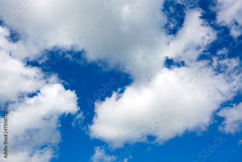 Sunny background with blue sky and white clouds as summer natural background.