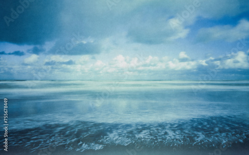 The North Sea photographed with a wooden pinhole camera, captured analogue on film. The small aperture makes for long exposure times in which sand, sea, water, sky and clouds mix with time.