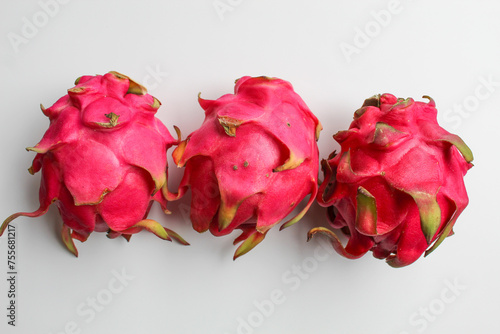 Red pitaya fruits. Three fresh dragon fruit, isolated on white background photo