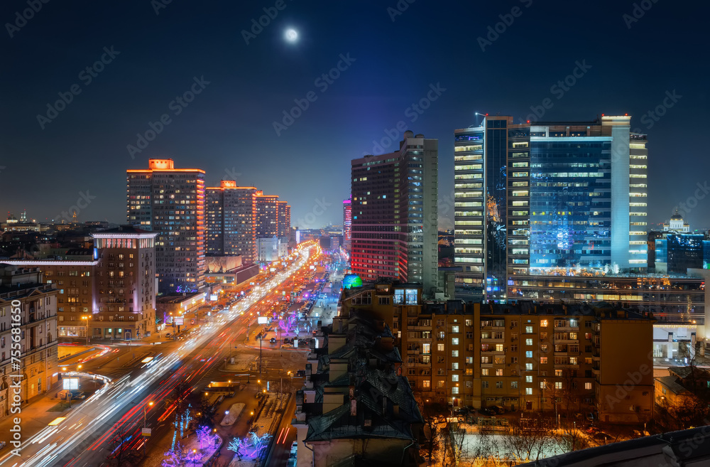 New Arbat Street, highway with moving cars at moony night in Moscow, Russia