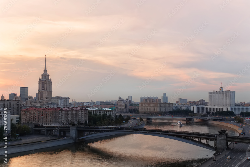 Smolensky Metro Bridge with moving train at evening in Moscow, Russia Smolensky Metro Bridge with moving train at evening in Moscow, Russia
