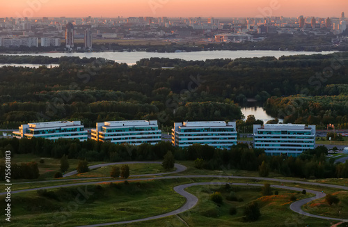 Business center with high buidlings, river and green forest in Moscow, Russia at summer evening photo