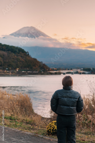Woman tourist with Fuji Mountain at Lake Kawaguchi, happy Traveler sightseeing Mount Fuji in Fujikawaguchiko, Yamanashi, Japan. Landmark for tourists attraction. Japan Travel, Destination and Vacation