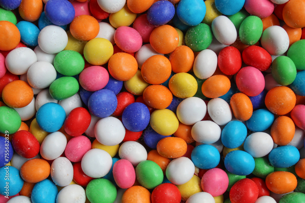 Background texture of biscuit balls with colorful coatings, flat lay or top view Background texture of biscuit balls with colorful coatings, flat lay or top view