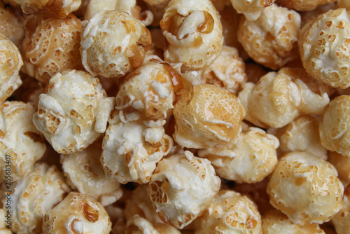 Background texture of caramel popcorn. Popcorns coated by melted sugar photo