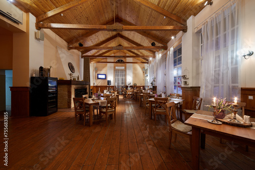  Interior of restaurant in evening. The interior of the restaurant is made in natural style.