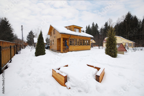 Wallpaper Mural Cozy wooden country cottage with playground among snow at winter day Torontodigital.ca