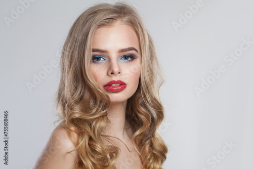 Glorious young fashion woman with healthy blonde hair and make-up on white background