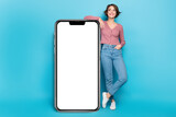 Photo pretty lady posing near big smartphone screen display new phone model advert promo isolated blue color background