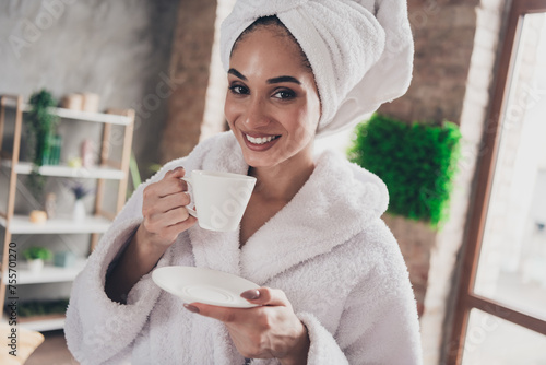 Photo portrait of pretty young girl drinking delicious tea relax head wrapped towel dressed bath robe beauty routine home concept