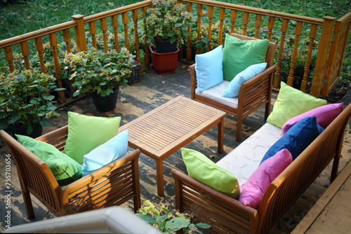 Empty cozy terrace with couch, table, chairs with pillows for resting