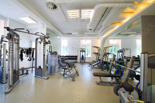 Empty modern gym with fitness equipment, mirror for sport training