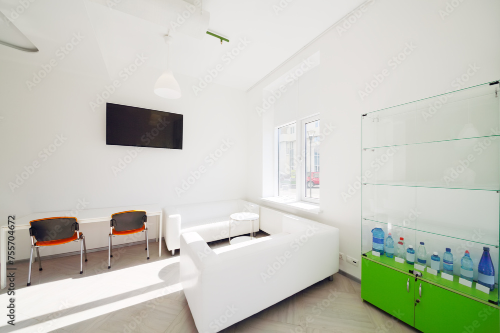 Empty white light room with sofa for resting, display, table Empty white light room with sofa for resting, display, table