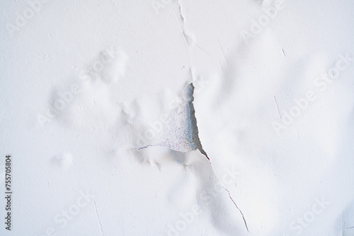 Cracked white paint on the ceiling close-up
