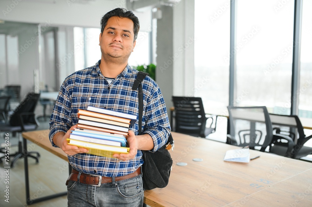 Fototapeta premium Portrait of cheerful male international Indian student with backpack. Education concept
