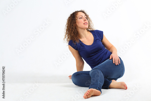 Wallpaper Mural Happy pretty barefoot woman in jeans poses on floor in white studio Torontodigital.ca