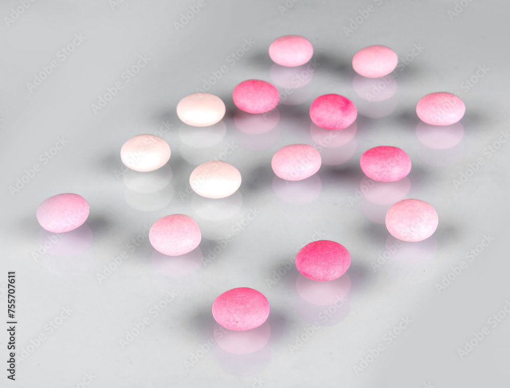 pink and white pills on white pink and white pills on white