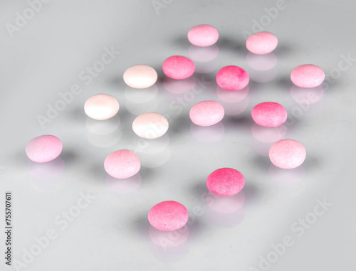 pink and white pills on white