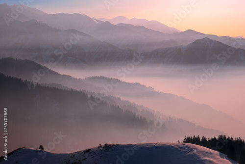 Mountain valley shrouded in a light haze on the eve of sunset