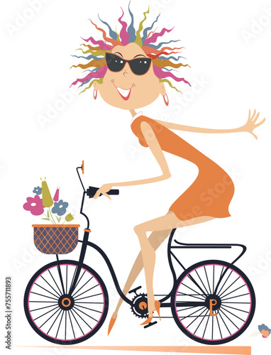 Pretty young cycling woman with bouquets of flowers in the basket. Cycling woman carries bouquets of flowers in the basket 