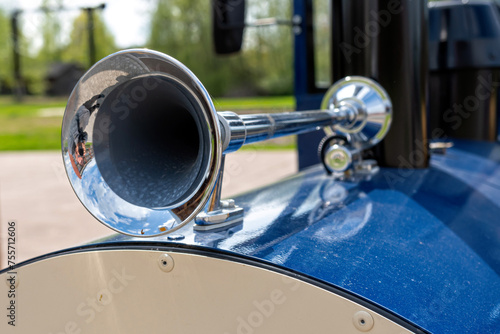 Close-up of the vintage horn on a blue car in the park photo