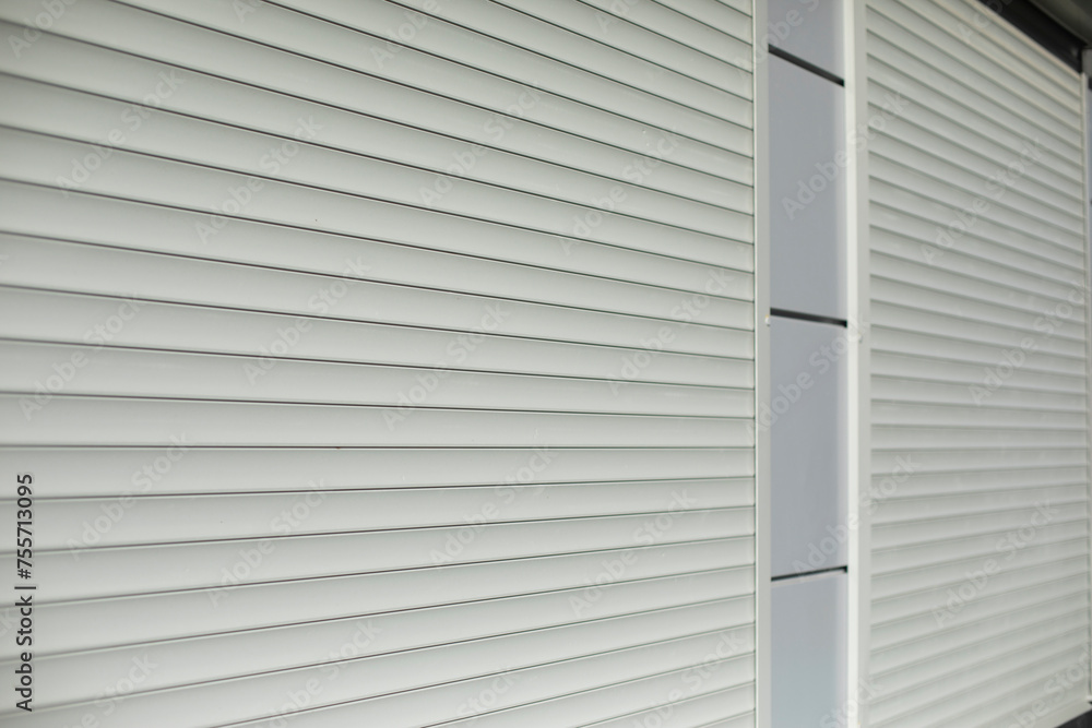 Blinds on window. Shutters on windows of office. Grey shutters.