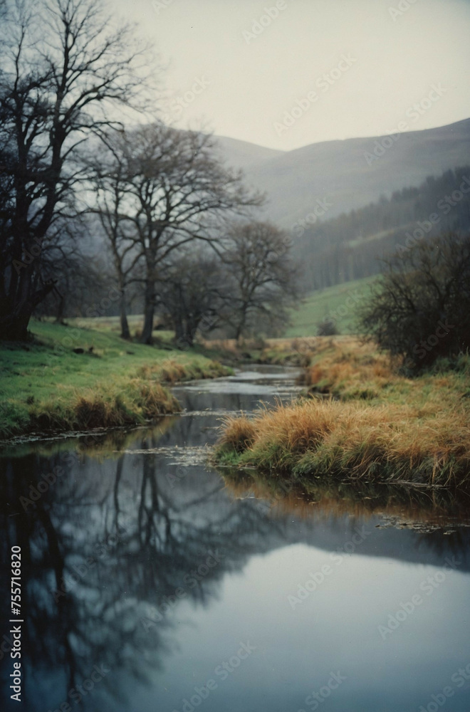 A winding river flows through a misty valley, reflecting the surrounding trees and hills A winding river flows through a misty valley, reflecting the surrounding trees and hills