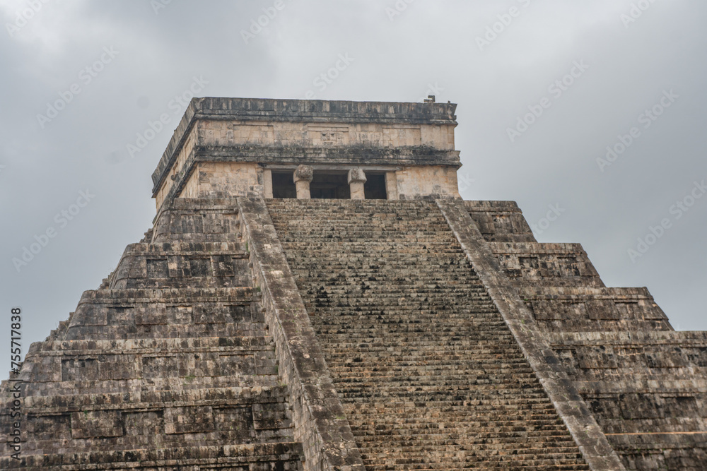 Sunny day with blue sky and white clouds. El Castillo (The Kukulkan Temple) of Chichen Itza, mayan pyramid in Yucatan, Mexico