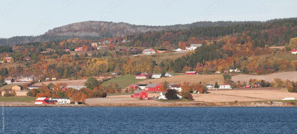 Norwegian landscape with wooden houses on a coast of fjord