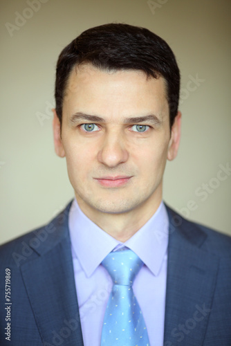 Smiling elegance brunet man in business suit with tie in studio