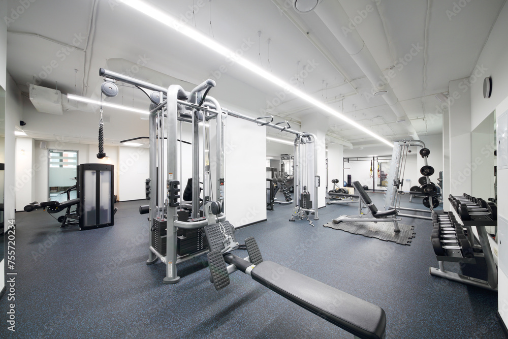 Fototapeta premium New and light fitness center with many modern sport equipment