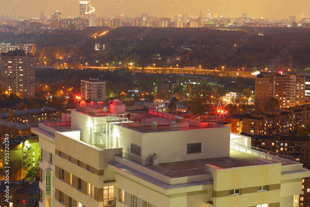 Roof of tall building with signal lights and night panorama of Moscow, Russia Roof of tall building with signal lights and night panorama of Moscow, Russia