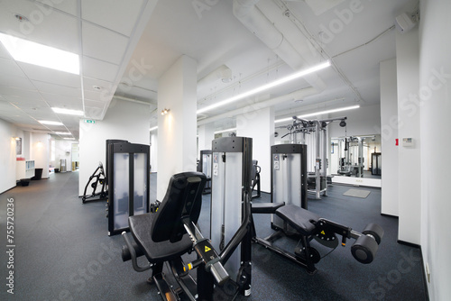 Empty modern and light fitness center with many sport equipment