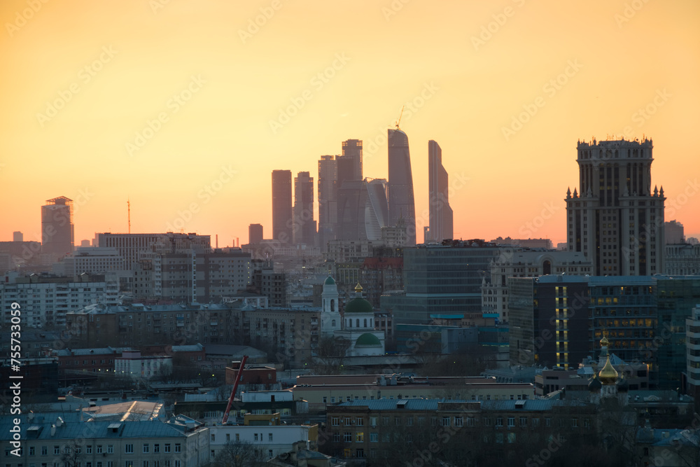 Obraz premium Panorama of roofs, domes of churches and skyscrapers during sunset in Moscow