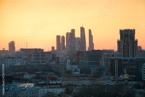 Panorama of roofs, domes of churches and skyscrapers during sunset in Moscow