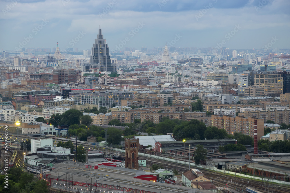 Railway station, residential buildings and roofs at summer evening in Moscow, Russia