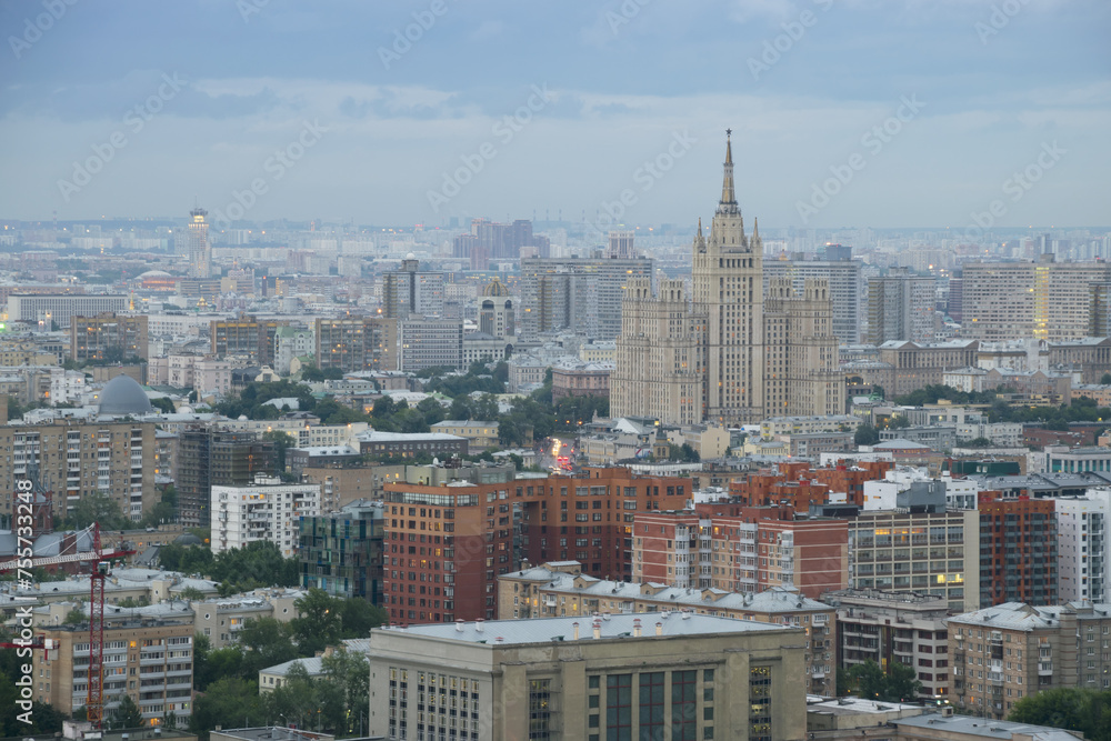Fototapeta premium Residential building on square Kudrinskaya (Stalin skyscraper) at overcast evening in Moscow, Russia