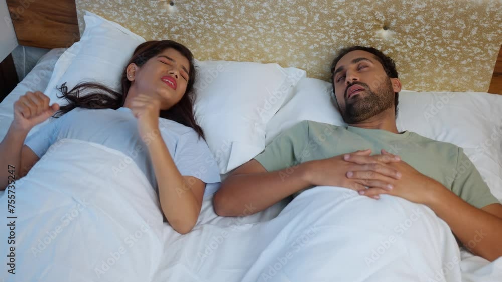 Worried frustrated wife due to loud snoring sound of husband while sleeping on at night - concept of couple problems, disturbance and discomfort. Worried frustrated wife due to loud snoring sound of husband while sleeping on at night - concept of couple problems, disturbance and discomfort.