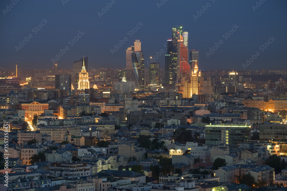 Residential buildings, roofs and skyscrapers at summer night in Moscow, Russia