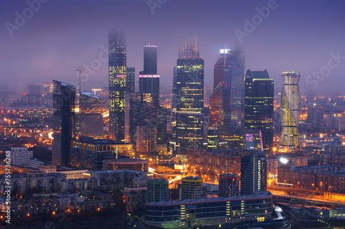 Skyscrapers of Moscow City business complex in fog at night in Moscow, Russia