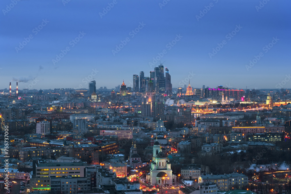 Panoramic view of Moscow City business complex, Stalin skyscrapers, residential buildings and churches at evening in Moscow, Russia